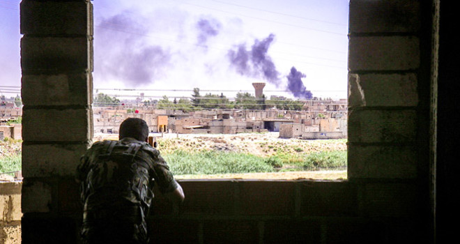 An MFS (Syriac Military Council) soldier on the frontline in Hassake, Syria, looking for ISIS militants hiding in homes only 700 meters away.