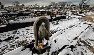 Statue of St. Mary standing among ruins of Hurricane in NJ